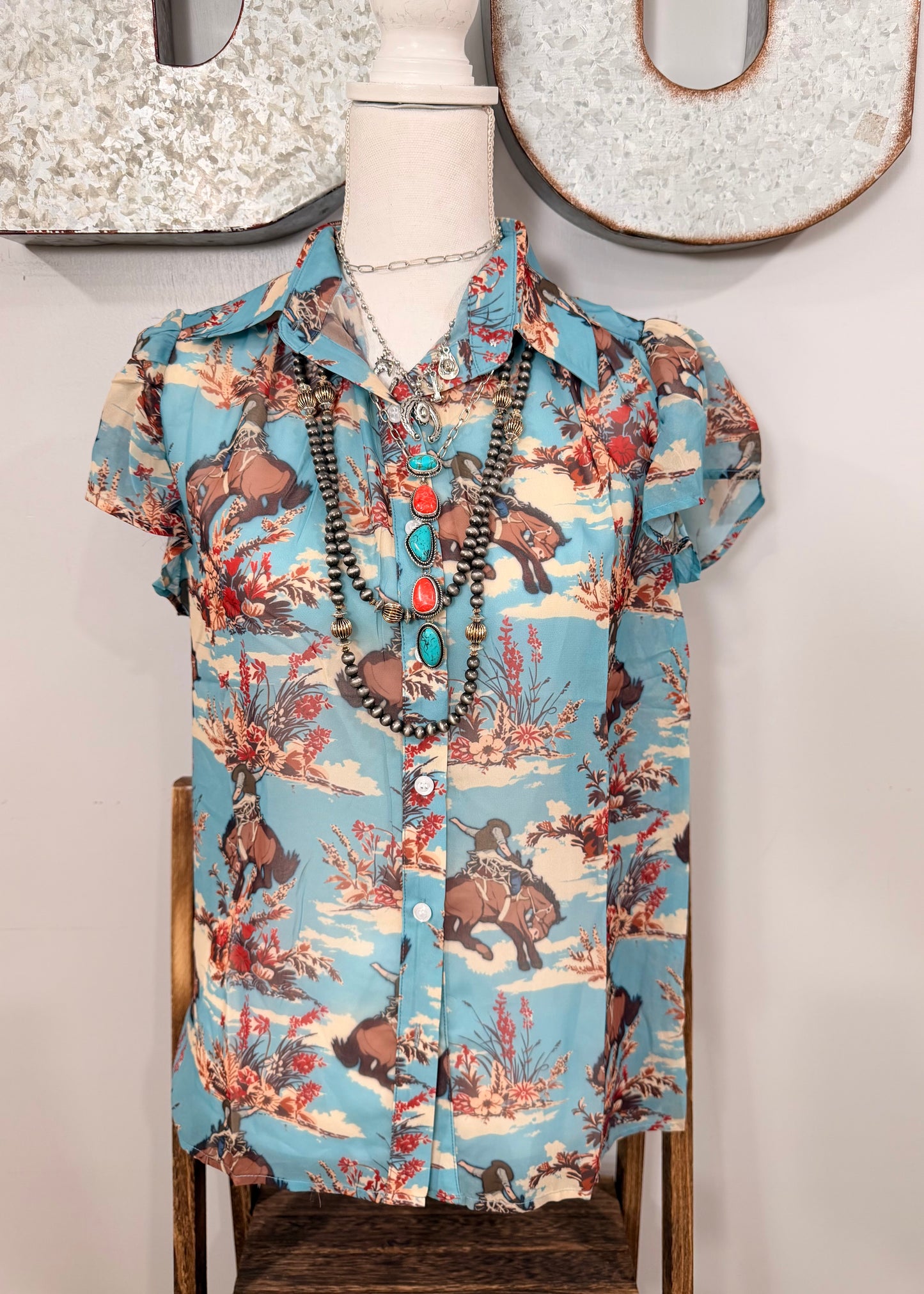 The Floral Bucking Horse Top
