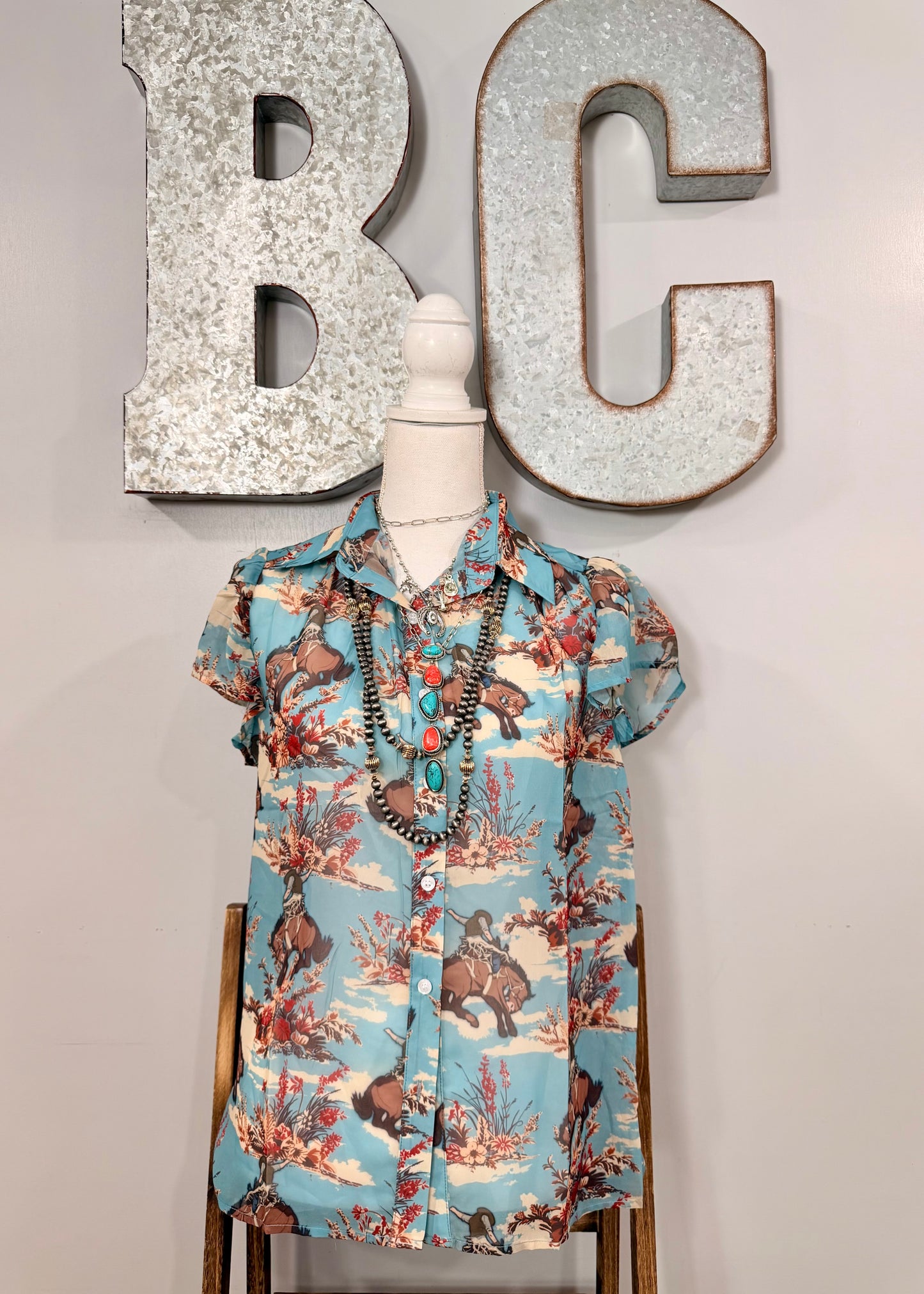 The Floral Bucking Horse Top