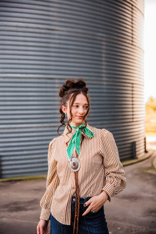 Angled front view of the Buck Scallop Top showing brown-and-cream stripes, a button front and softly gathered sleeves.