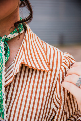 Close-up of the Buck Scallop Top’s brown-and-cream striped collar with brown scalloped edging and a gathered shoulder.