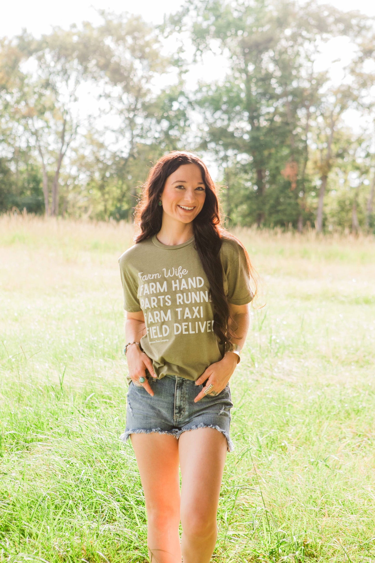 Woman wearing a green t-shirt with text in a field