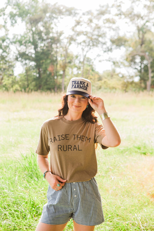 Woman wearing a cap and t-shirt with text in a field