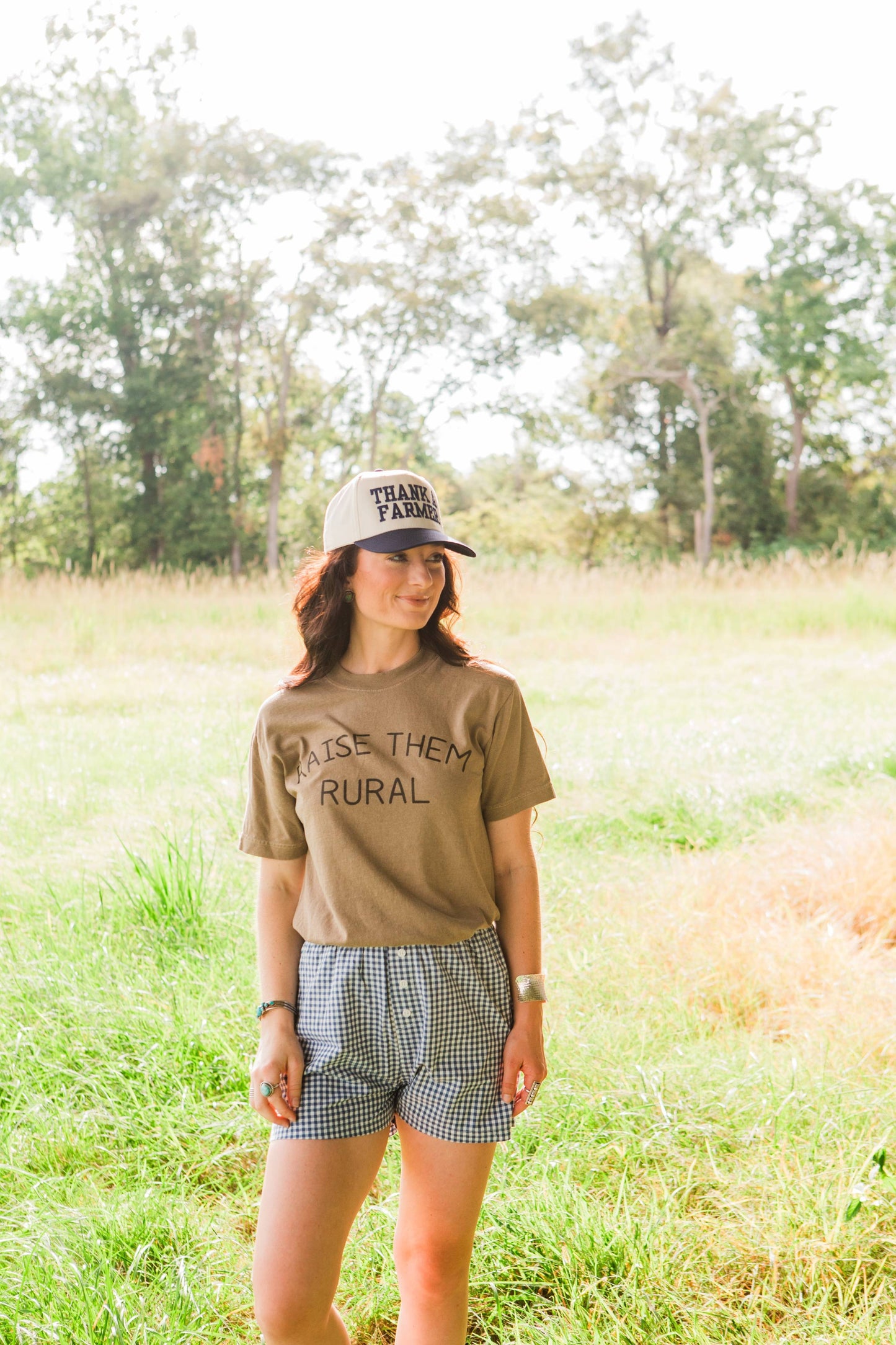 Woman wearing a t-shirt and cap in a field
