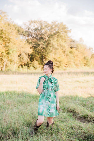 Full outfit view of the green Laurel Gingham Sheer Top styled as a dress with Western boots. Lady the Brand