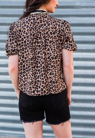Back view of the Lexington Leopard Bow Blouse showing gathered back detailing, short puff sleeves and a curved hem.