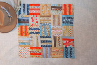 Log Cabin Shorty Wildrag by XOXO Art & Co, a 26 x 26-inch scarf made from 70% cotton and 30% silk.