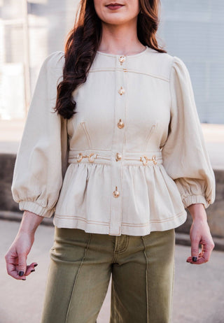 Front view of the cream Sutton Top showing puff sleeves, gold-tone buttons, contrast stitching and a gathered waist.