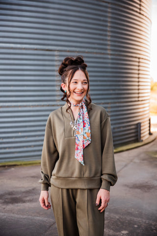 Front view of the olive Weekend Trail pullover showing dropped shoulders, long sleeves and a banded hem.