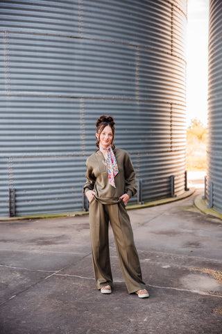 Sadie modeling the olive Weekend Trail Knit Set with her hands in the pants pockets, showing the wide-leg silhouette.
