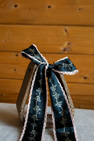 Allie Falcon Devotions navy silk twilly with long patterned tails, small heart accents and pale scalloped crochet edging.