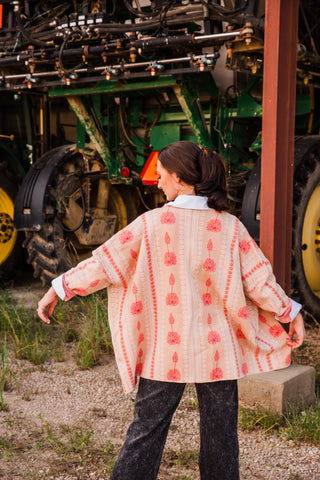 Back view of the Allie Falcon Winnie Boyfriend Cardigan, showing its oversized shape and vertical pink floral patterned bands.