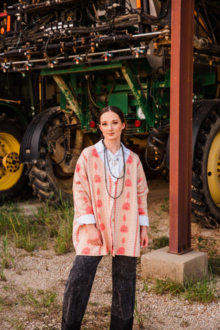 Winnie Boyfriend Cardigan by Allie Falcon worn buttoned over a white blouse with layered necklaces and washed black jeans.
