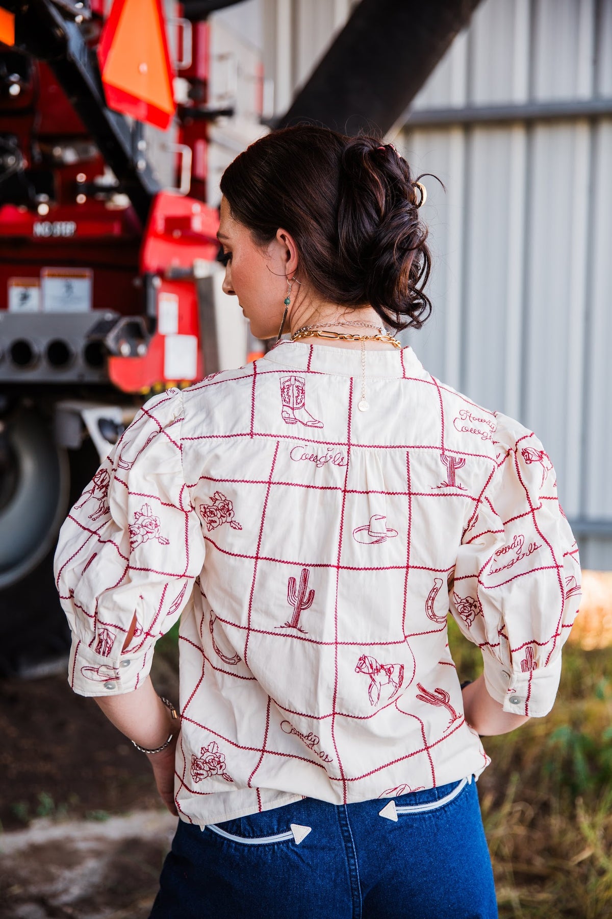 Back view of Prairie Post Blouse with red Western embroidery and puff sleeves