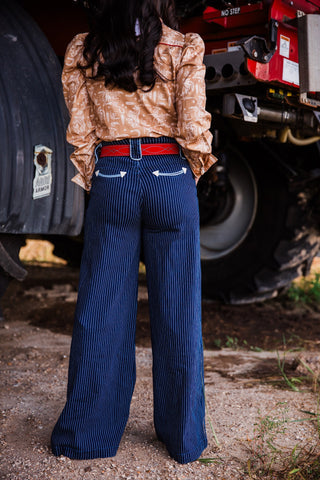 Women’s 1 1/2 inch red suede Western belt styled with dark wash wide leg jeans by double j saddlery