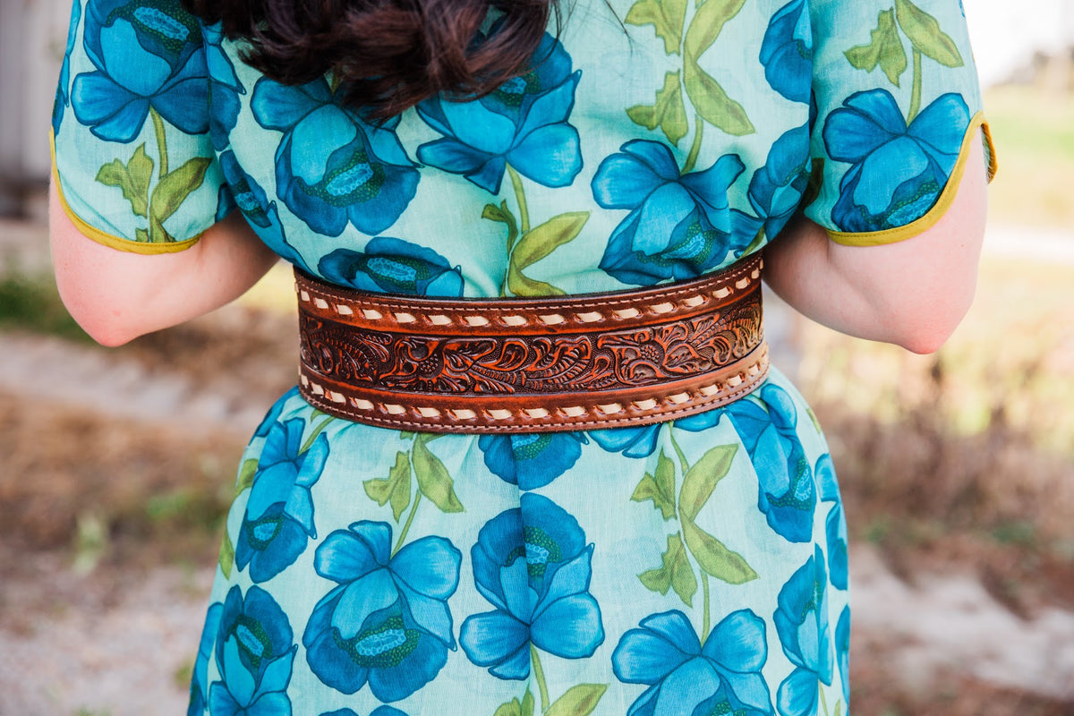 Close-up of the Brown Vintage Buck Stitched Belt’s wide back panel with carved floral tooling and contrasting cream stitching.