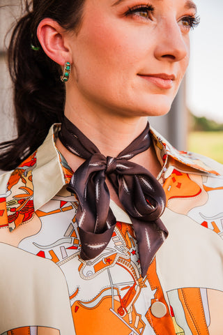Close-up of the Buckstitch Brown Twilly neck bow, showing pale stitch-pattern accents, soft loops and pointed ends.