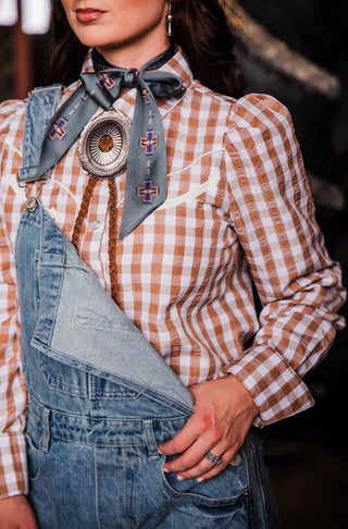 Women’s Western pearl snap shirt with brown gingham print, long sleeves and snap cuffs