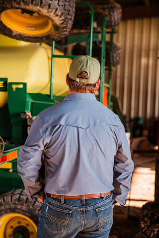 Back view of the CORE Blue long sleeve pearl snap shirt, showing its vented Western yoke and solid blue fabric.