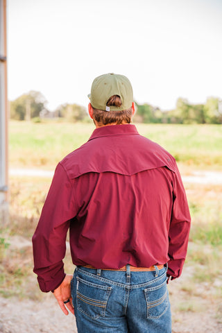 Back view of the CORE Maroon long sleeve pearl snap shirt, showing its vented Western yoke and solid maroon fabric.