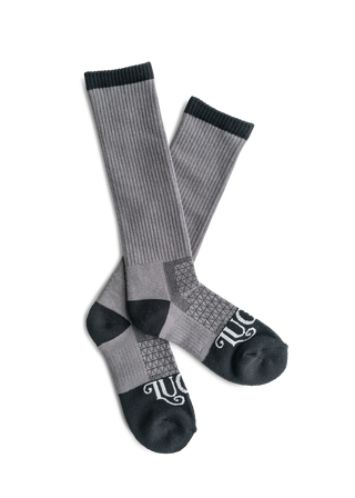 Gray knee-high socks with black accents on a white background