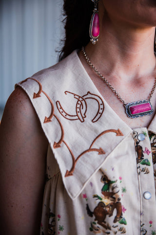 Close-up of Howdy Hanny Western dress embroidered horseshoe yoke