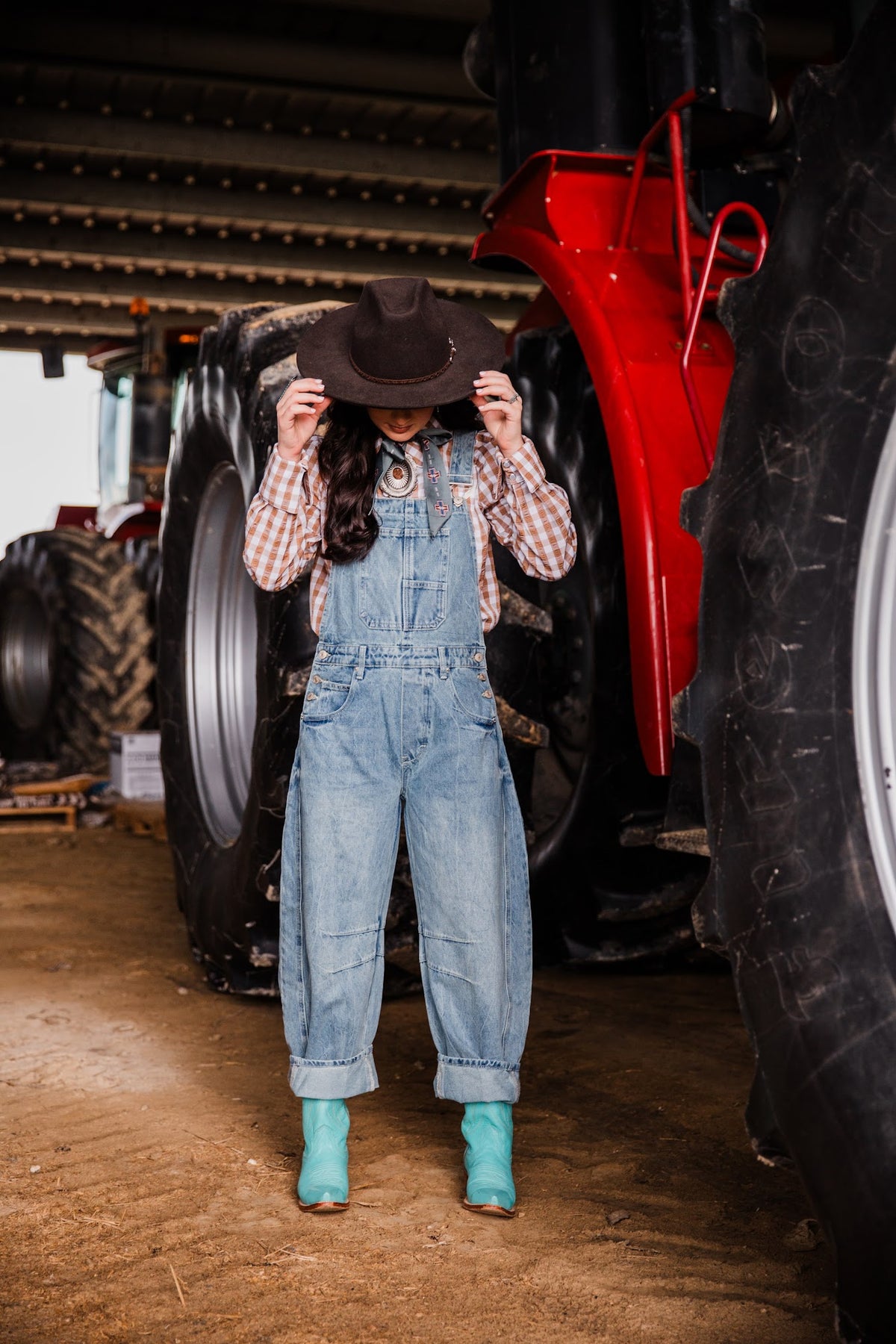 Women’s oversized denim overalls with cuffed barrel legs styled for a modern Western outfit