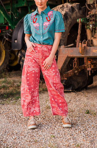 Front view of Desert Bandana Western Barrel Jeans in washed pink with cream paisley print, curved legs and seam panels.