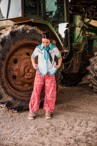 Desert Bandana Western Barrel Jeans showing the rounded leg shape and cream paisley print beneath an untucked Western shirt.
