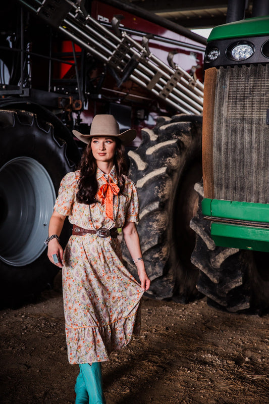 Women’s Western midi dress with multicolor floral print styled with cowboy boots and belt