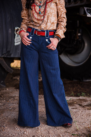 Blue Bonnet women’s dark denim pinstripe wide leg Western jeans styled with a red leather belt