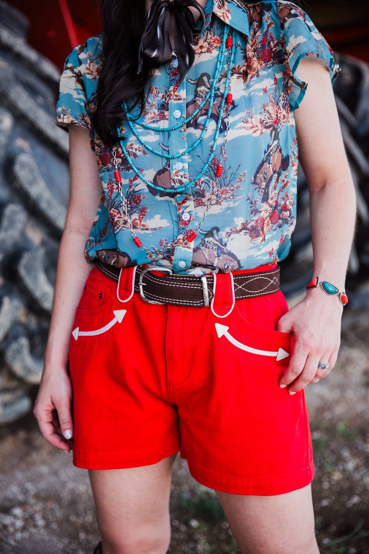 Front view of red cowgirl denim shorts with white Western pocket piping by howdy hanny