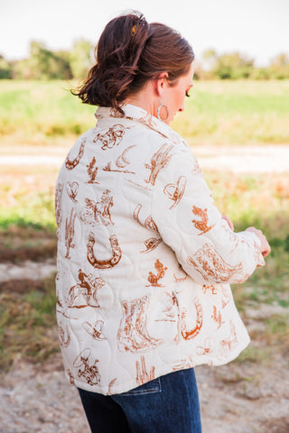 Rear side view of the Frontier Jacket, showing curved stitched panels and brown Western motifs across the cream back and sleeve.