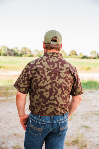 Back view of the Gage Camo short sleeve pearl snap shirt, showing its Western back yoke and brown and olive camouflage.