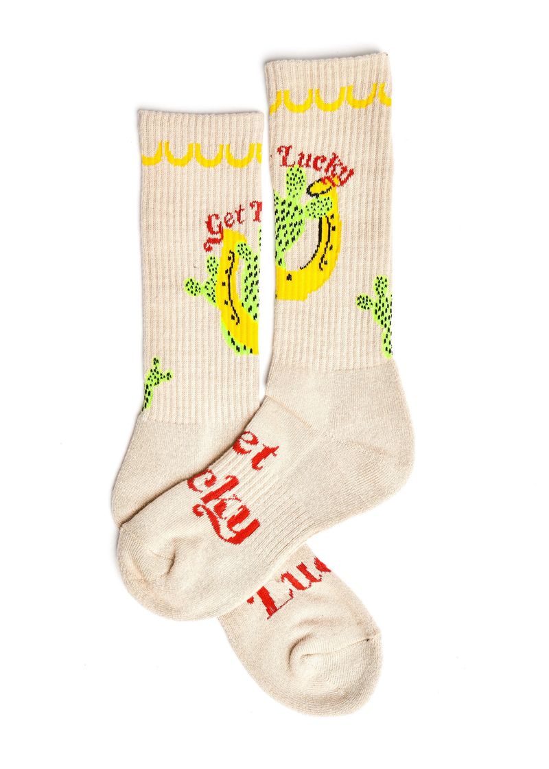 Beige socks with lucky charm design on a white background