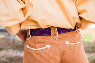 Back detail of Howdy Hanny Polly tan Western shorts showing cream-trimmed pockets with arrow-shaped ends and wide belt loops.