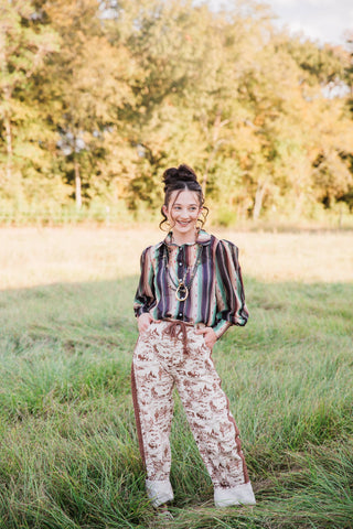 Full-length front view of Howdy Hanny Ranch Life Barrel Jeans with brown Western print, waist tie and cuffed barrel legs.