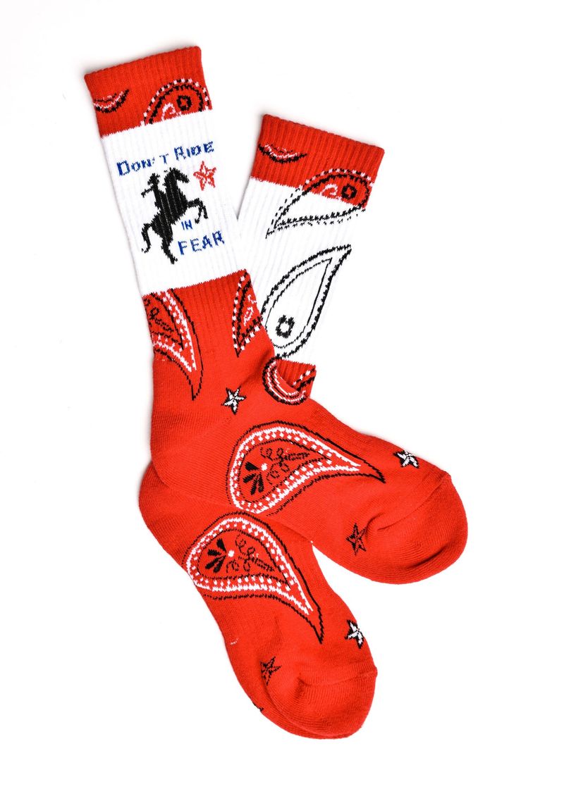 Red bandana-themed socks with a white label on a white background