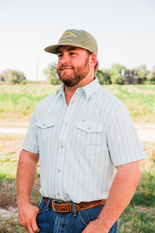 Angled view of the Jack in Green short sleeve pearl snap shirt, showing the striped front, Western yokes and short sleeves.
