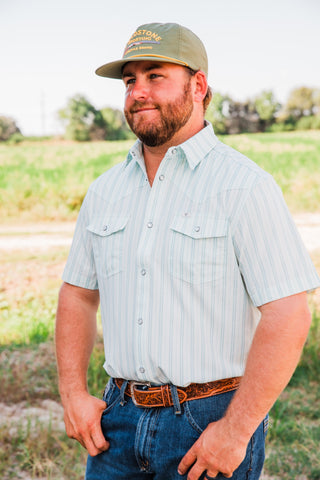 Closer view of the Jack in Green pearl snap shirt, showing fine stripes, a pointed collar and snap-flap chest pockets.