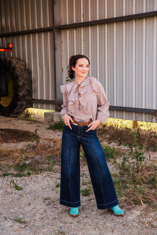 Jincy Top brown gingham ruffle blouse styled with wide-leg dark jeans, a brown belt and turquoise cowboy boots.