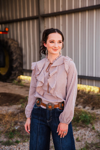 Front view of the Kaufman tan leather Western belt on a model, showing a rectangular buckle and decorative side conchos.