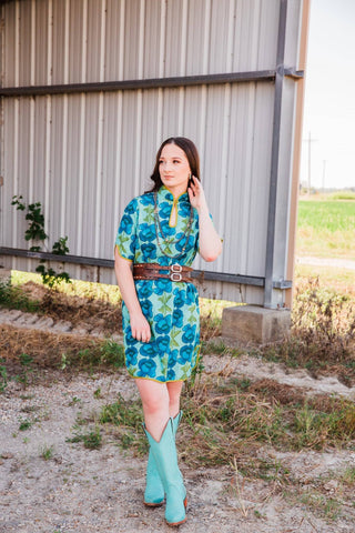 Front view of Sadie wearing size S/M in the Lissie Mini Dress, showing blue florals, short sleeves, and an above-knee hem.