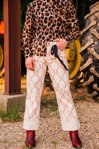 Sadie models Extra Small Lucky Babe Pants with a black scarf tied at the waist, showing front pockets and cream cuffed hems.