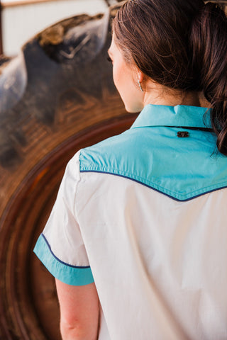 Back detail of the Old School Puncher Pearl Snap showing a pointed turquoise yoke with navy piping above the white body.