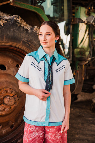 Old School Puncher Pearl Snap by Lucky & Blessed worn untucked with a dark neck scarf, showing turquoise placket and hem trim.
