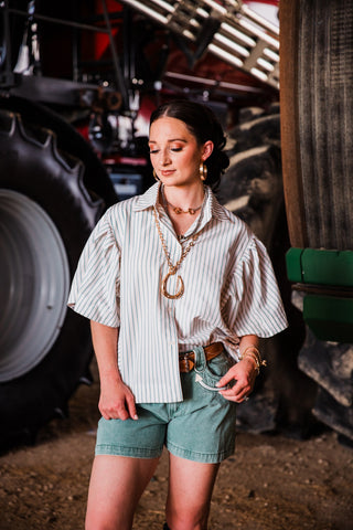 Women’s oversized seersucker button-down top with blue and tan stripes and short sleeves