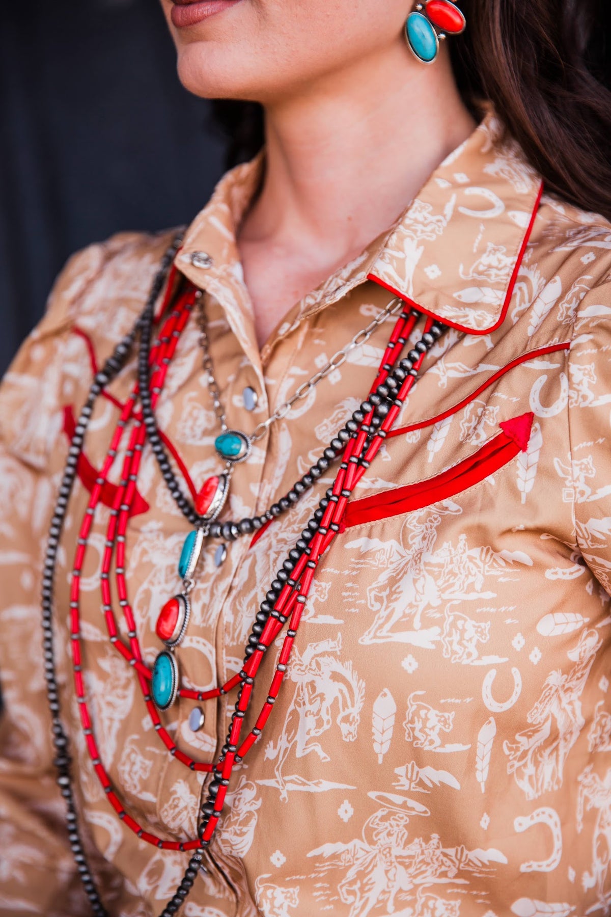 Women’s Western cowboy print shirt with pearl snap front, pointed collar and red piping