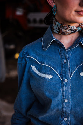 Howdy Hanny women’s denim pearl snap shirt styled with Western shorts and silk scarf close up 
