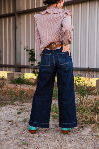 Back view of Sammy high rise dark wash wide-leg jeans, featuring square patch pockets and contrasting stitching at the hems.