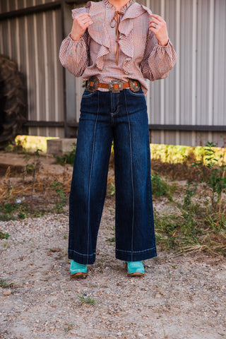 Front view of Sammy high rise dark wash jeans, showing wide legs, vertical front seams and contrasting hem stitching.